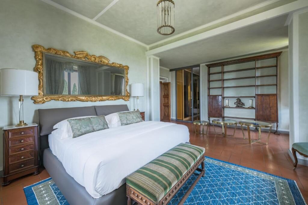 Master bedroom with gilt mirror and library
